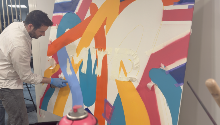 Un participant peint sur la toile collective de MTD