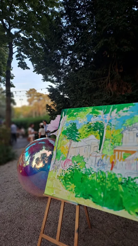 Toile de live painting en cours dans le jardin du Pavillon Royal à Paris, pendant une soirée d'entreprise